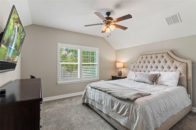 carpeted bedroom featuring vaulted ceiling, baseboards, and a ceiling fan