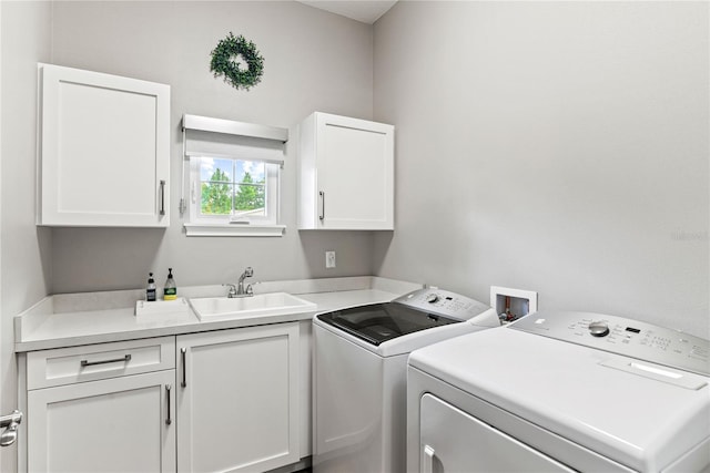 clothes washing area featuring cabinet space and washing machine and dryer
