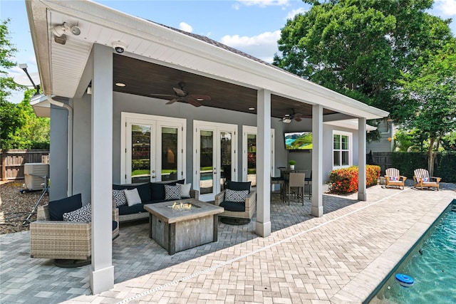 view of patio / terrace with a ceiling fan, french doors, fence, and an outdoor living space with a fire pit
