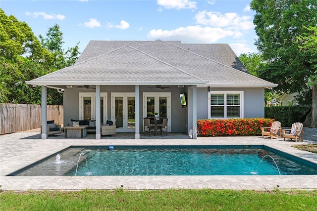 view of swimming pool with french doors, a ceiling fan, fence, a patio area, and an outdoor hangout area