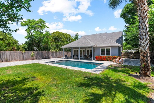 view of swimming pool featuring a patio and french doors