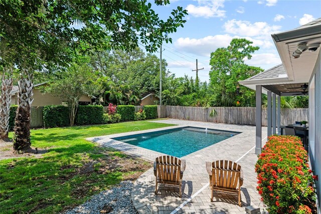 view of swimming pool featuring a ceiling fan and a patio