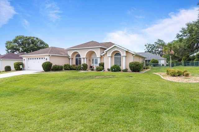 mediterranean / spanish house with stucco siding, concrete driveway, and a garage