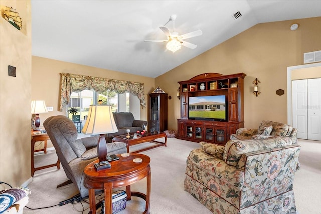 living area with carpet flooring, vaulted ceiling, and ceiling fan