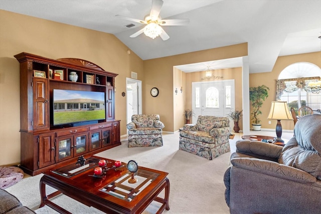 living area with carpet floors, plenty of natural light, ceiling fan, vaulted ceiling, and a chandelier