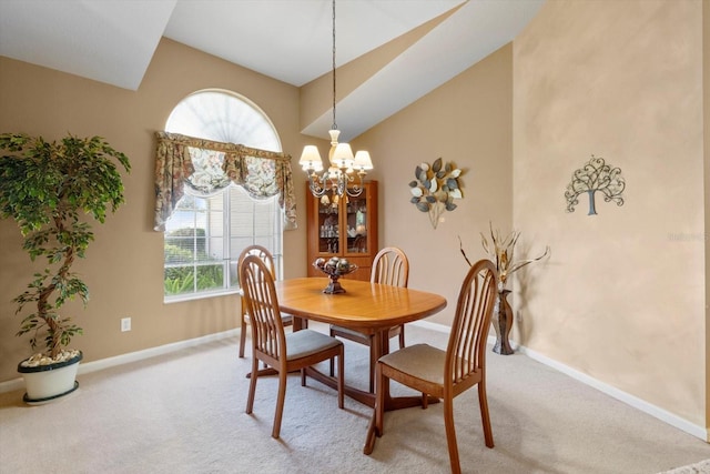 carpeted dining room with baseboards, lofted ceiling, and a chandelier