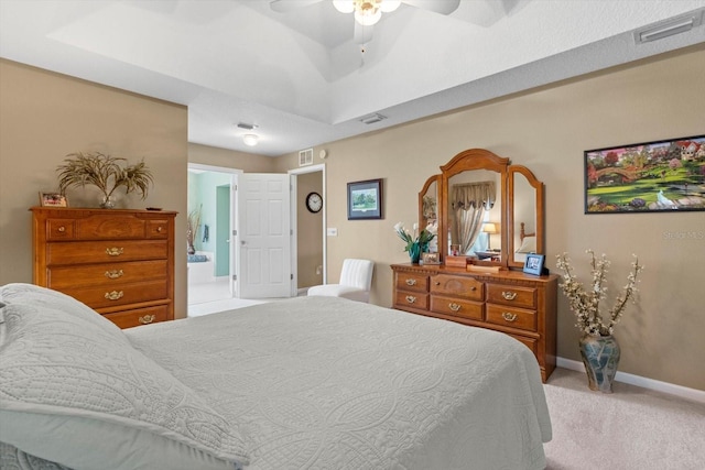 bedroom featuring light carpet, baseboards, connected bathroom, and ceiling fan