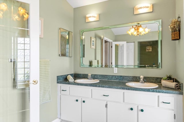 full bath with a chandelier and double vanity