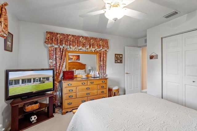 bedroom with a closet, carpet, and ceiling fan