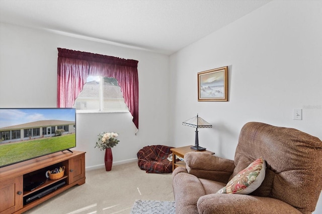 living area with light carpet and baseboards