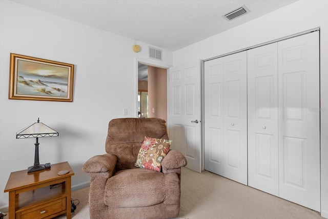 sitting room featuring light colored carpet