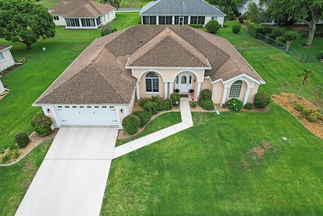 view of front of house with stucco siding, roof with shingles, driveway, and an attached garage