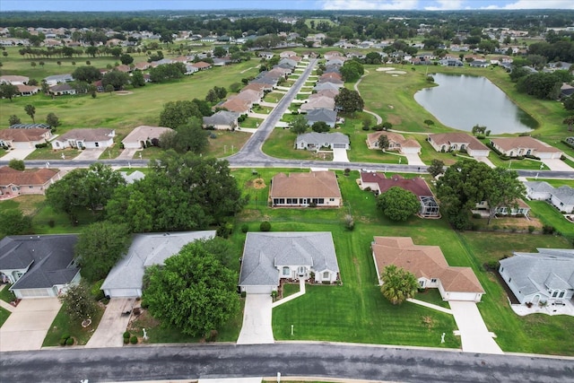 aerial view of property and surrounding area with nearby suburban area and a large body of water