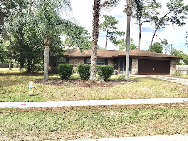3152 Clewiston St, Deltona, FL 32738 - ranch-style home featuring an attached garage, driveway, brick siding, and a front lawn