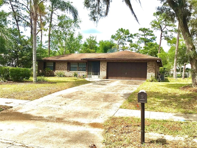 3152 Clewiston St, Deltona, FL 32738 - single story home featuring a garage, brick siding, driveway, and a front lawn