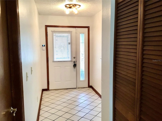 3152 Clewiston St, Deltona, FL 32738 - entryway with light tile patterned floors, a textured ceiling, and baseboards