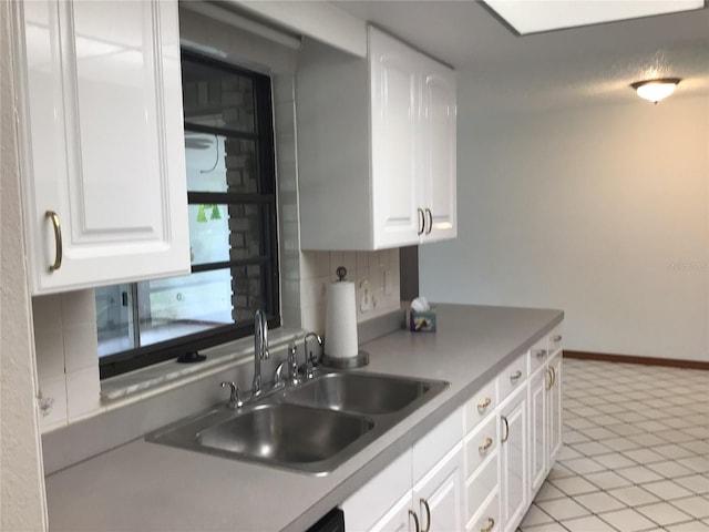 3152 Clewiston St, Deltona, FL 32738 - kitchen with a sink, white cabinetry, decorative backsplash, baseboards, and light countertops