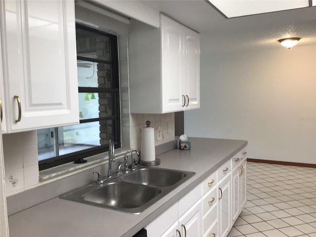3152 Clewiston St, Deltona, FL 32738 - kitchen with a sink, tasteful backsplash, white cabinets, and light countertops