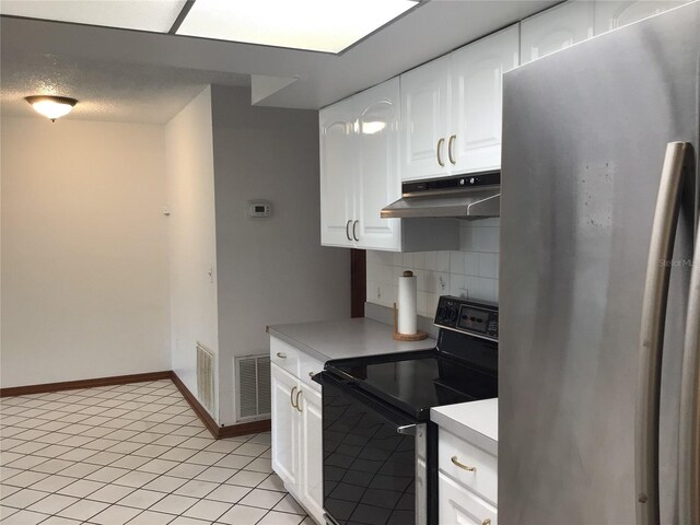 3152 Clewiston St, Deltona, FL 32738 - kitchen with freestanding refrigerator, black / electric stove, under cabinet range hood, and light countertops