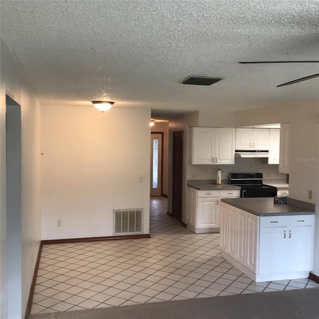 3152 Clewiston St, Deltona, FL 32738 - kitchen featuring electric stove, dark countertops, a textured ceiling, white cabinetry, and under cabinet range hood