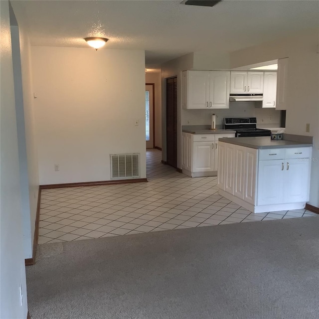 3152 Clewiston St, Deltona, FL 32738 - kitchen with electric range oven, under cabinet range hood, light colored carpet, light tile patterned floors, and white cabinets