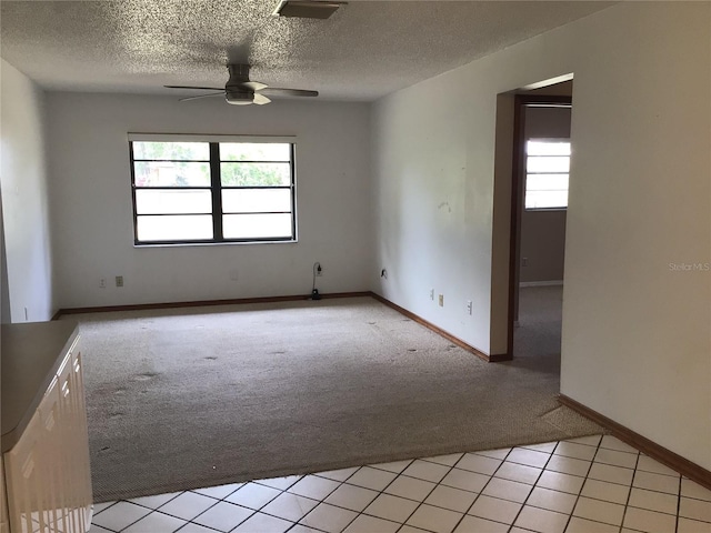 3152 Clewiston St, Deltona, FL 32738 - unfurnished room featuring light colored carpet, a ceiling fan, plenty of natural light, a textured ceiling, and baseboards