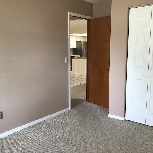 3152 Clewiston St, Deltona, FL 32738 - unfurnished bedroom featuring carpet, baseboards, and stainless steel fridge