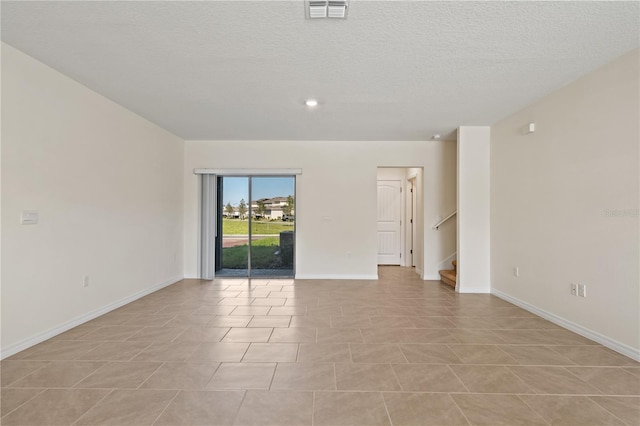 17081 Water Spring Blvd, Winter Garden, FL 34787 - spare room with stairway, baseboards, light tile patterned flooring, a textured ceiling, and recessed lighting