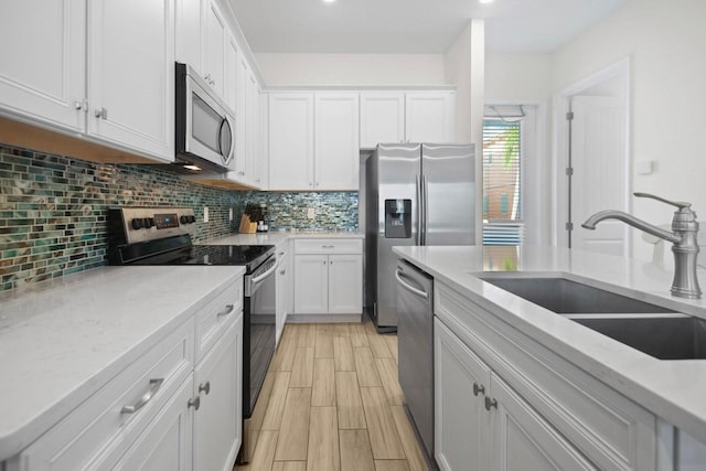 8045 Lost Shaker Ln, Kissimmee, FL 34747 - kitchen featuring stainless steel appliances, white cabinetry, decorative backsplash, and wood tiled floors