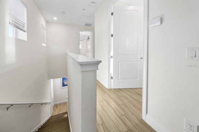 8045 Lost Shaker Ln, Kissimmee, FL 34747 - hallway featuring an upstairs landing, wood finished floors, and attic access