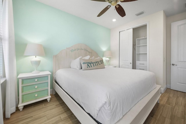 8045 Lost Shaker Ln, Kissimmee, FL 34747 - bedroom featuring wood finished floors, a closet, a ceiling fan, and recessed lighting