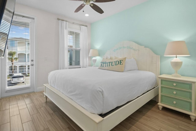 8045 Lost Shaker Ln, Kissimmee, FL 34747 - bedroom with access to exterior, multiple windows, wood finished floors, a ceiling fan, and recessed lighting