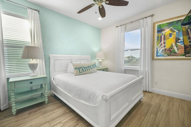 8045 Lost Shaker Ln, Kissimmee, FL 34747 - bedroom featuring multiple windows, wood finished floors, and ceiling fan
