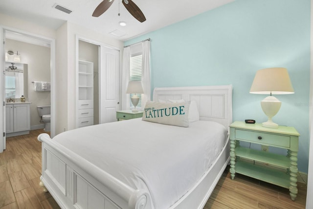 8045 Lost Shaker Ln, Kissimmee, FL 34747 - bedroom with light wood-type flooring, a closet, connected bathroom, and a ceiling fan