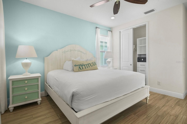 8045 Lost Shaker Ln, Kissimmee, FL 34747 - bedroom with wood finished floors, a closet, ceiling fan, and recessed lighting