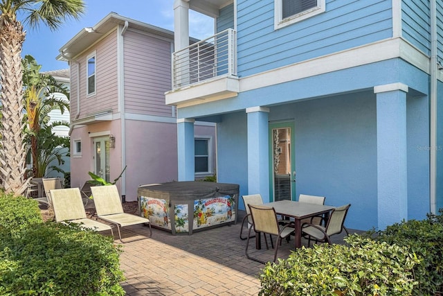 8045 Lost Shaker Ln, Kissimmee, FL 34747 - patio / terrace with a covered hot tub, a patio area, and outdoor dining area