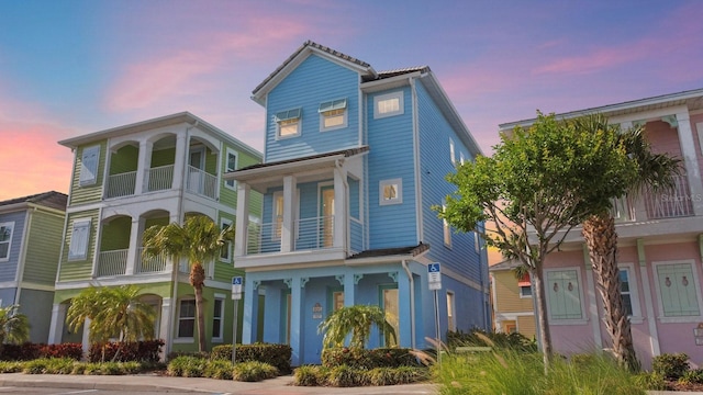 8045 Lost Shaker Ln, Kissimmee, FL 34747 - view of front facade featuring a balcony and a porch