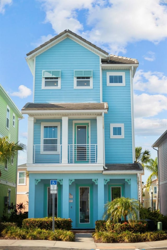 8045 Lost Shaker Ln, Kissimmee, FL 34747 - view of front facade with a balcony and covered porch