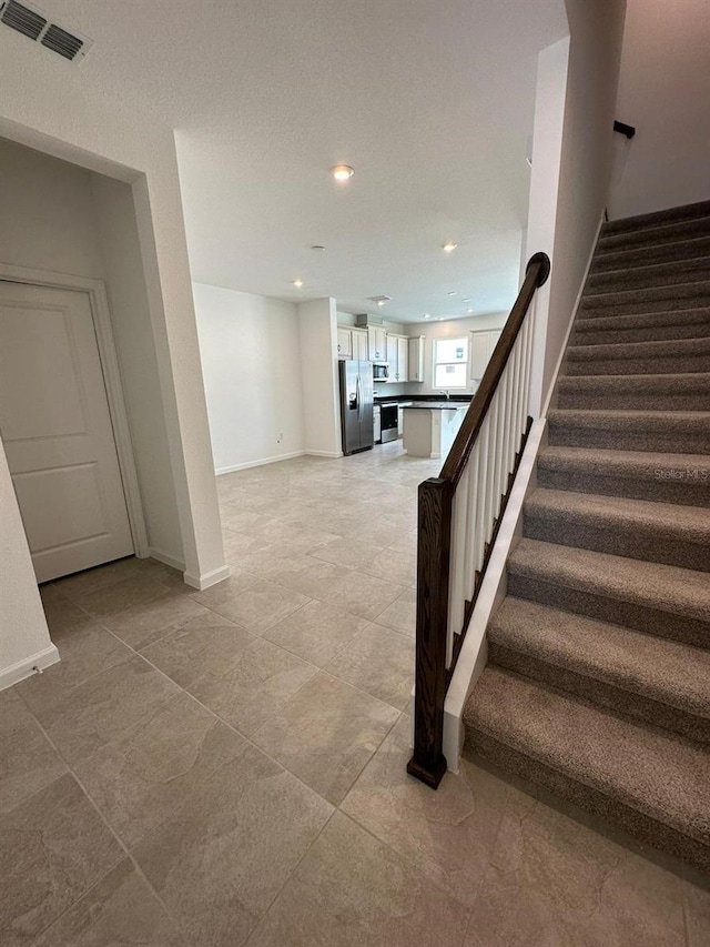 stairs featuring recessed lighting and baseboards