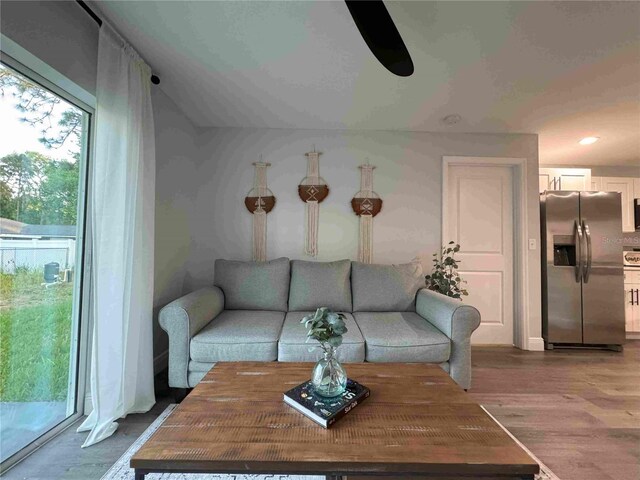 living area featuring wood finished floors and recessed lighting