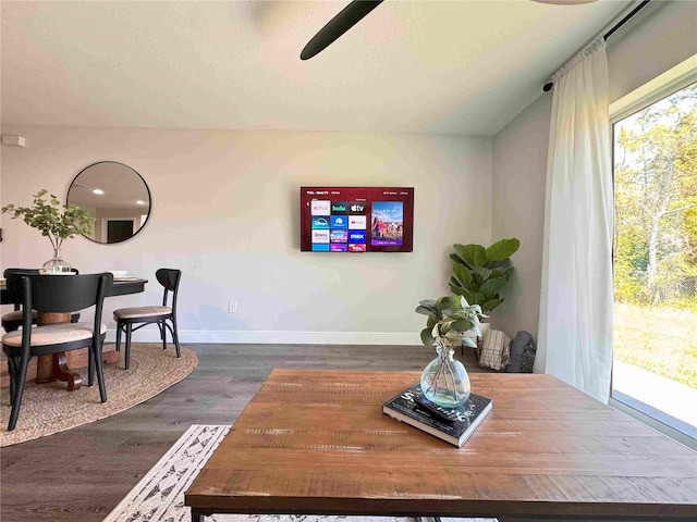 dining room featuring ceiling fan, wood finished floors, baseboards, and a textured ceiling