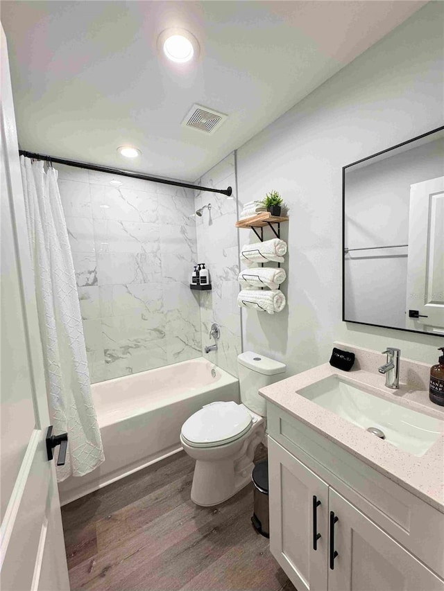 bathroom with wood finished floors, shower / bath combo with shower curtain, toilet, vanity, and recessed lighting