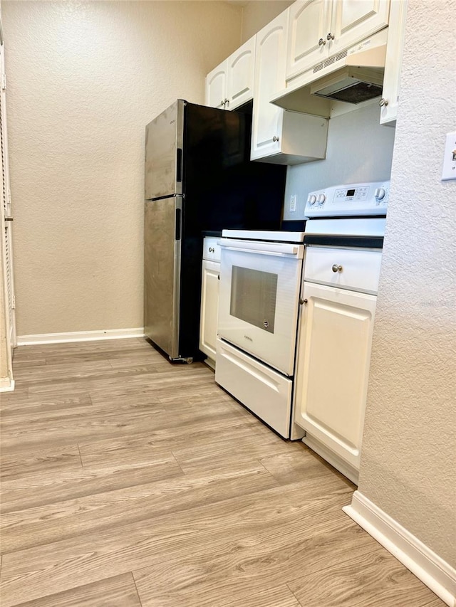 kitchen featuring under cabinet range hood, white electric range, a textured wall, white cabinetry, and baseboards