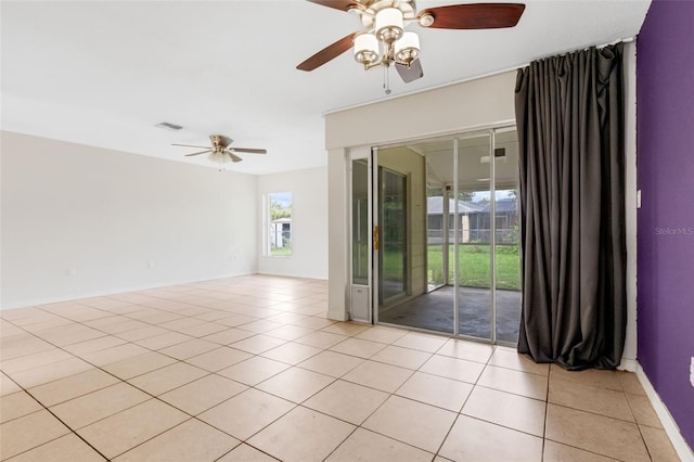 715 Wedge Ln, Poinciana, FL 34759 - spare room with ceiling fan, light tile patterned floors, and baseboards