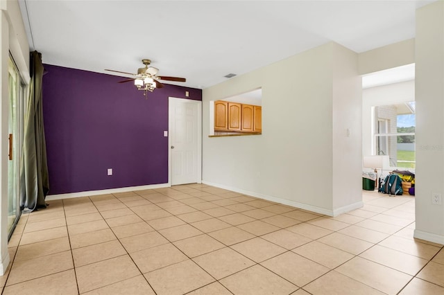 715 Wedge Ln, Poinciana, FL 34759 - spare room featuring ceiling fan, light tile patterned flooring, and baseboards
