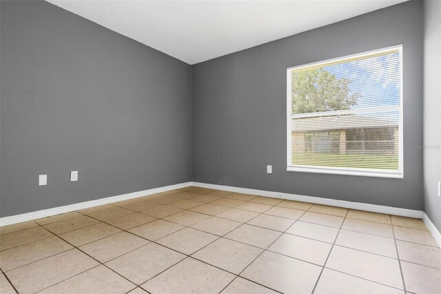 715 Wedge Ln, Poinciana, FL 34759 - spare room with light tile patterned flooring and baseboards