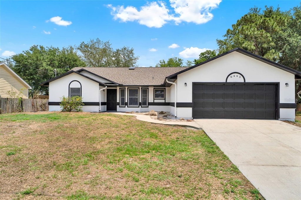6445 Beard Ave, Cocoa, FL 32927 - ranch-style house with a garage, stucco siding, driveway, and roof with shingles