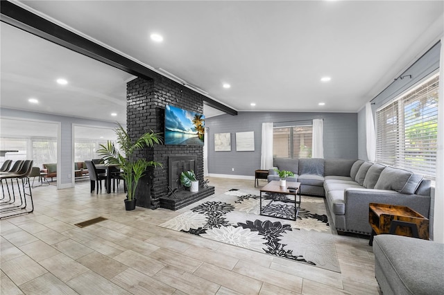 913 Moss Ln, Winter Park, FL 32789 - living room featuring healthy amount of natural light, recessed lighting, a brick fireplace, and ornamental molding