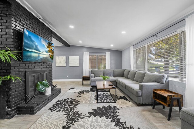 913 Moss Ln, Winter Park, FL 32789 - living room with light wood-style flooring, a fireplace, and crown molding