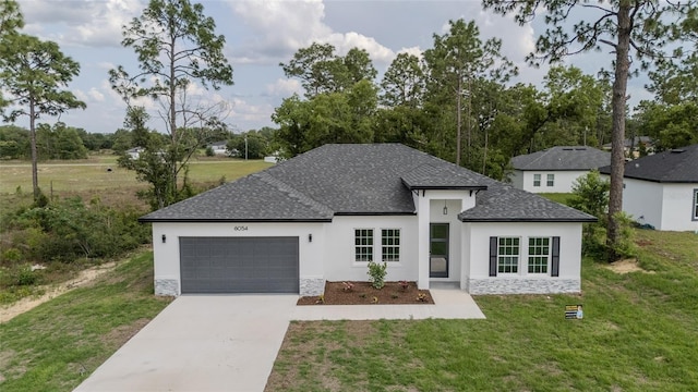 view of front of property with a garage, stucco siding, stone siding, concrete driveway, and a front yard